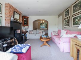 A living room with a sofa and a fireplace at Kiln Cottage Golant near Tywardreath