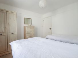 A bedroom with a bed and furniture at Kiln Cottage Golant near Tywardreath