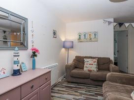 A living room with a sofa and decorative objects at Manorcombe 21 Honicombe Holiday Village near Gunnislake