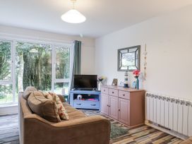 A living room with a sofa and television at Manorcombe 21 Honicombe Holiday Village near Gunnislake