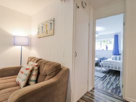 A living room with a sofa and door leading to a bedroom at Manorcombe 21 Honicombe Holiday Village near Gunnislake