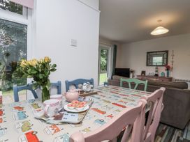 A dining room with a table set with tea and flowers at Manorcombe 21 Honicombe Holiday Village near Gunnislake