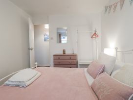 A bedroom with a bed and dresser at Manorcombe 21 in Honicombe Holiday Village near Gunnislake