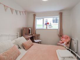 A bedroom with a bed and a window at Manorcombe 21 Honicombe Holiday Village near Gunnislake