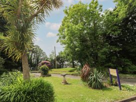 An outdoor area with flowering plants and trees at Mill House Barn 