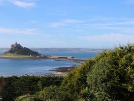 A view of an island with a castle and surrounding water at Mill House Barn in 