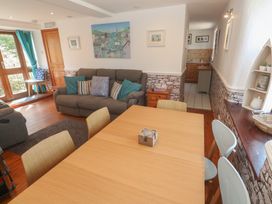 A living room with a dining table and sofa at Mill House Barn in Gulval near Penzance