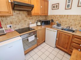 A kitchen with appliances and storage at Mill House Barn Gulval near Penzance