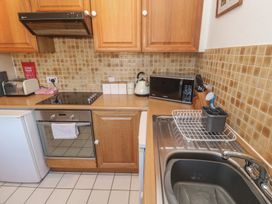 A kitchen with appliances and fixtures at Mill House Barn in Gulval near Penzance