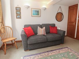 A living room with a sofa and chair at Mill House Barn in Gulval near Penzance