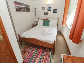 A bedroom with a bed and towels at Mill House Barn, Gulval near Penzance