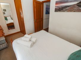 A bedroom with towels on a bed at Mill House Barn in Gulval near Penzance