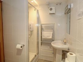 A bathroom with a shower, sink, and towel rail at Mill House Barn in Gulval near Penzance