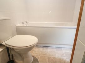 A bathroom with a toilet and bathtub at Mill House Barn in Gulval near Penzance