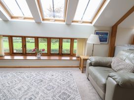 A living room with a sofa and windows at The Dairy in 
