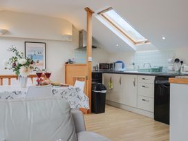A kitchen with table, chairs, and appliances at The Dairy in 