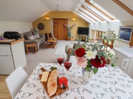 A living room with a sofa, chairs, and a table at The Dairy in 