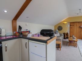 A kitchen with appliances and seating area at The Dairy 