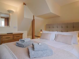 A bedroom with a double bed and a dresser at The Dairy in 