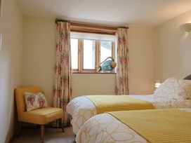 A bedroom with two beds and a window at The Dairy in 