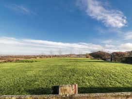 An outdoor view of a green field and trees at Pasture View