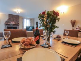A dining room with a table set for a meal at Pasture View in Sneatonthorpe near Whitby