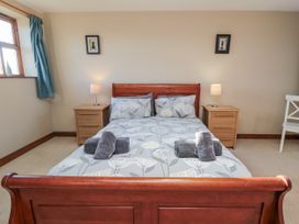A bedroom with a bed and bedside tables at Pasture View in Sneatonthorpe near Whitby
