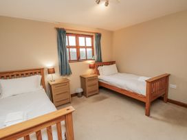 A bedroom with two beds and a window at Pasture View Sneatonthorpe near Whitby