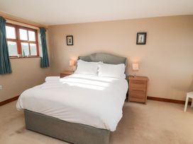 A bedroom with a double bed and nightstands at Pasture View in Sneatonthorpe near Whitby
