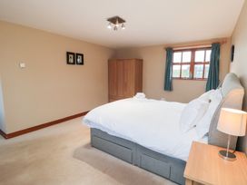 A bedroom with a bed and a cupboard at Pasture View in Sneatonthorpe near Whitby
