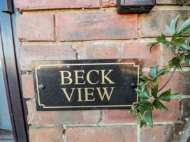 A nameplate on a brick wall at Beck View