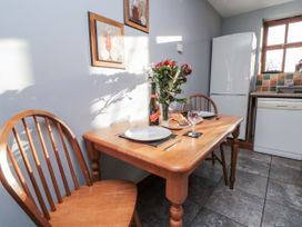A kitchen with a dining table set for dinner at Beck View in Whitby