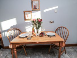 A dining room with a table set for two at Beck View in Whitby
