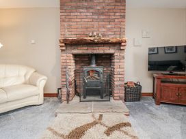 A living room with a fireplace and sofa at Beck View in Whitby