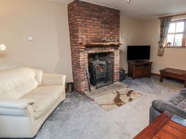 A living room with a fireplace and a TV at Beck View in Whitby