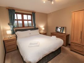 A bedroom with a double bed and furniture at Beck View in Whitby
