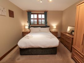 A bedroom with a bed and dressers at Beck View in Whitby