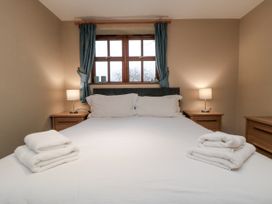 A bedroom with a bed and bedside lamps at Beck View in Whitby