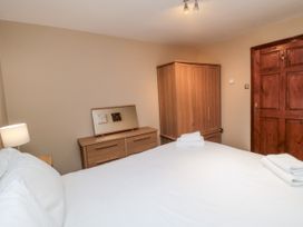 A bedroom with a bed and wardrobe at Beck View in Whitby