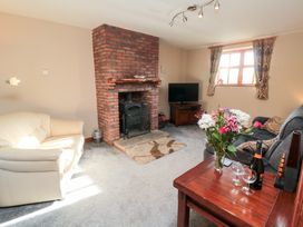 A living room with a fireplace and sofa at Beck View in Whitby