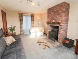A living room with a fireplace and sofa at Beck View in Whitby