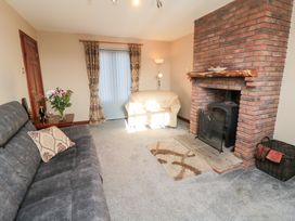 A living room with a fireplace and sofas at Beck View in Whitby