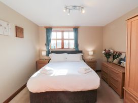 A bedroom with a bed and furniture at Beck View in Whitby