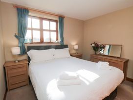 A bedroom with a bed and nightstands at Beck View in Whitby