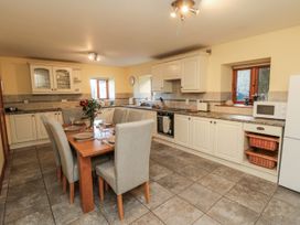 A kitchen with a table and chairs at Wheelhouse Cottage in Sneatonthorpe near Whitby