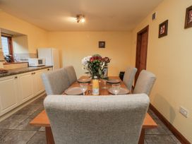 A dining room with a table and chairs at Wheelhouse Cottage in Sneatonthorpe near Whitby