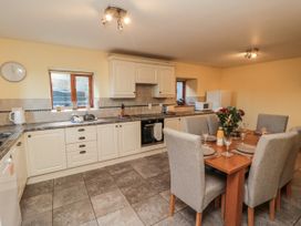 A kitchen with a table and chairs at Wheelhouse Cottage Sneatonthorpe near Whitby