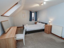 A bedroom with a bed and dresser at Wheelhouse Cottage Sneatonthorpe near Whitby