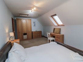 A bedroom with a bed and furniture at Wheelhouse Cottage Sneatonthorpe near Whitby
