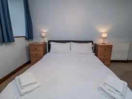 A bedroom with a bed and bedside tables at Wheelhouse Cottage Sneatonthorpe near Whitby